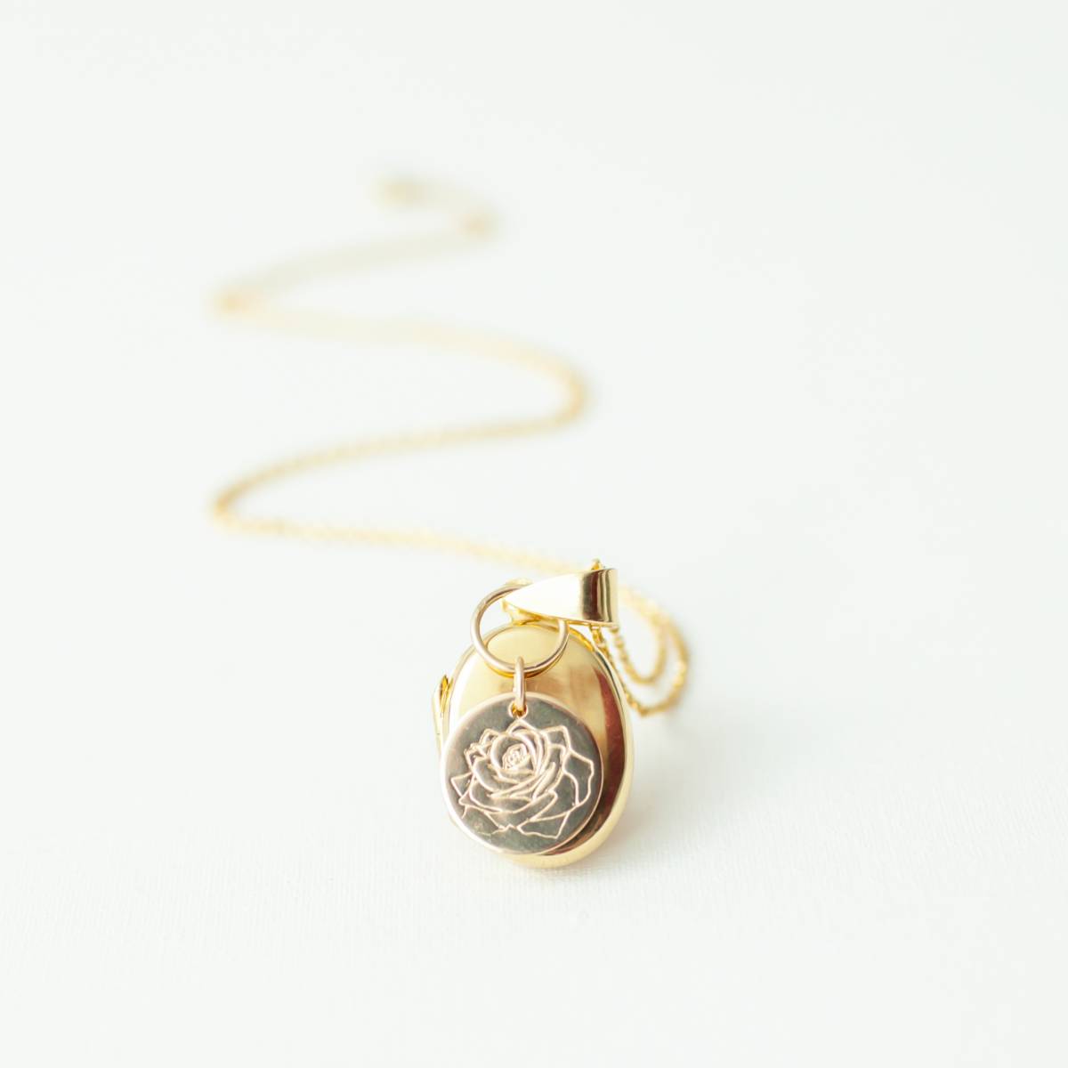 oval gold filled locket with birth month disc with a rose on it